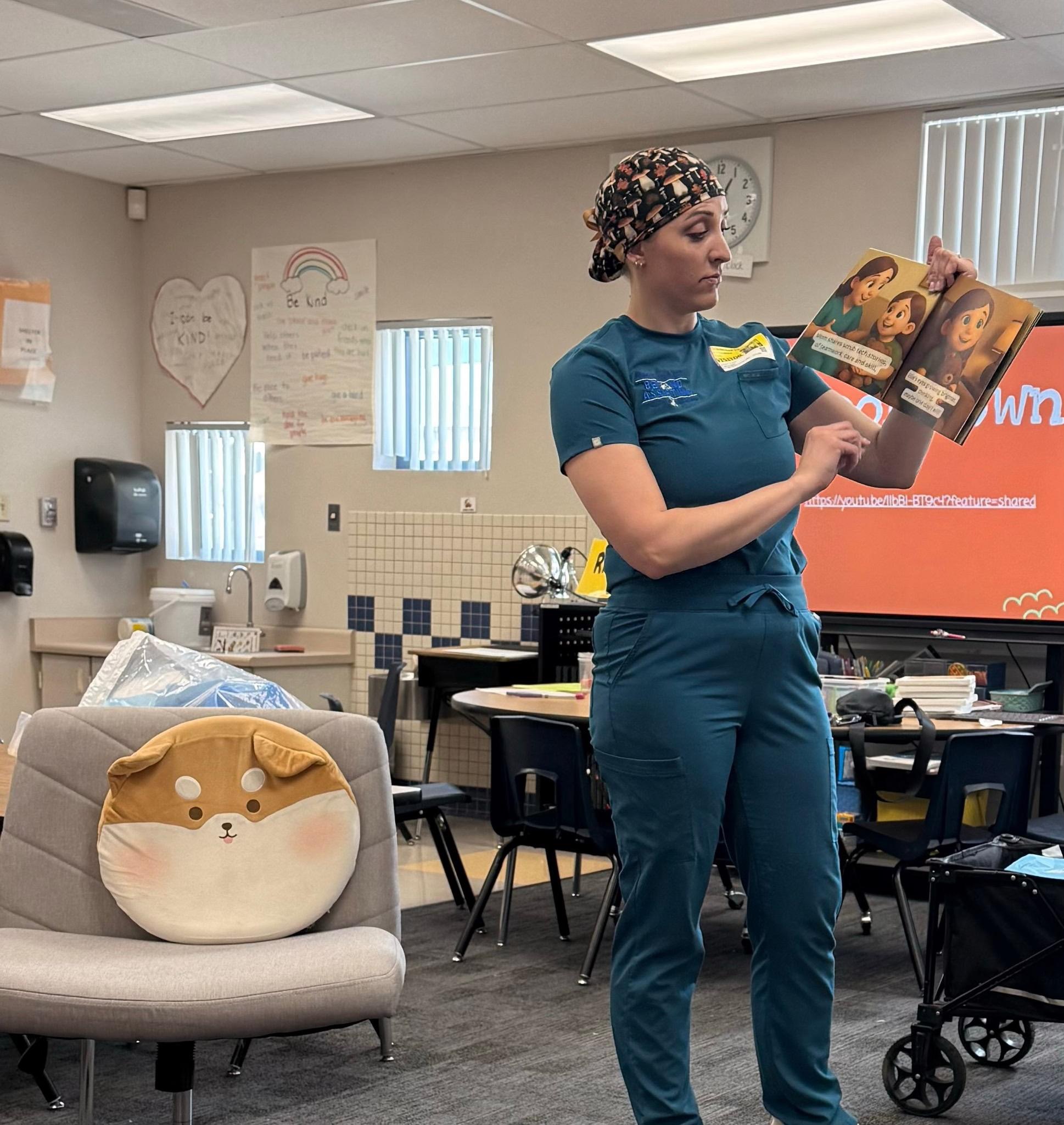 Alyssa Ellis teaching with an educational resource